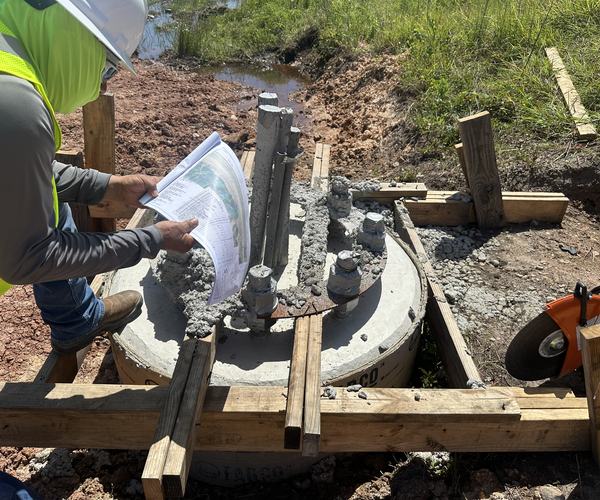 Checking plans on an anchor bolt foundation